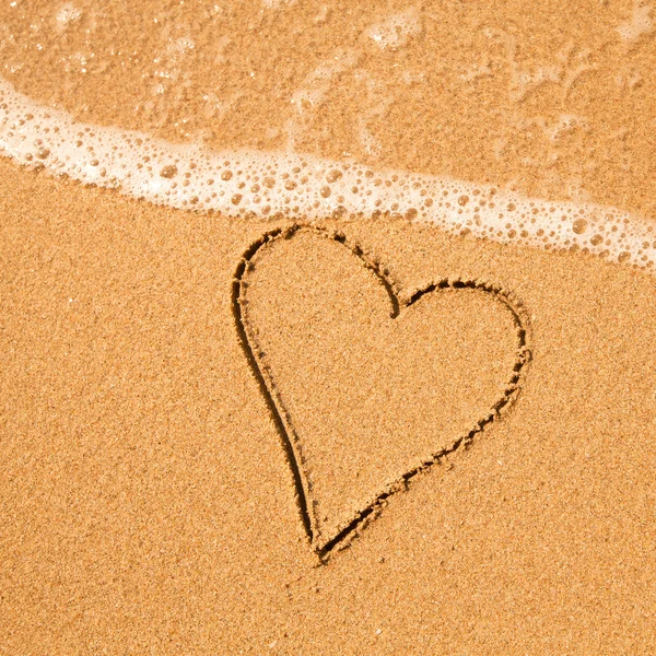 Shape of the heart of the sea on the beach in Valentine Day. Royalty Free Stock Images