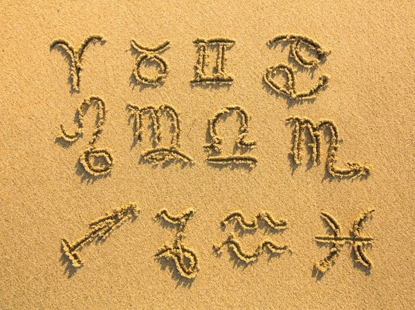 Set of zodiac signs drawn on sand. — Stockfoto