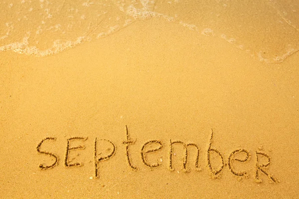 September - skriven på sand — Stockfoto