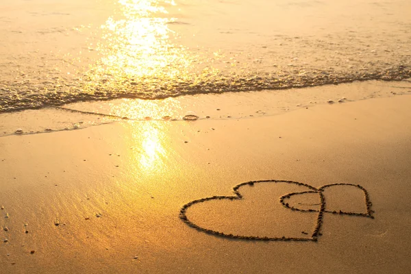 Hearts drawn on the sand Stock Image