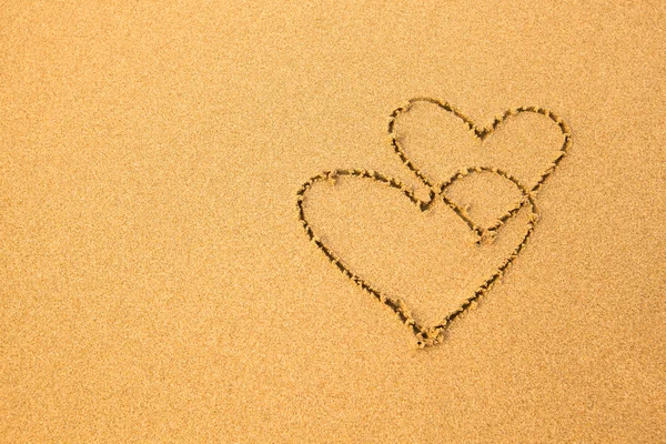 Shape of the two hearts on sand — Stock Photo, Image