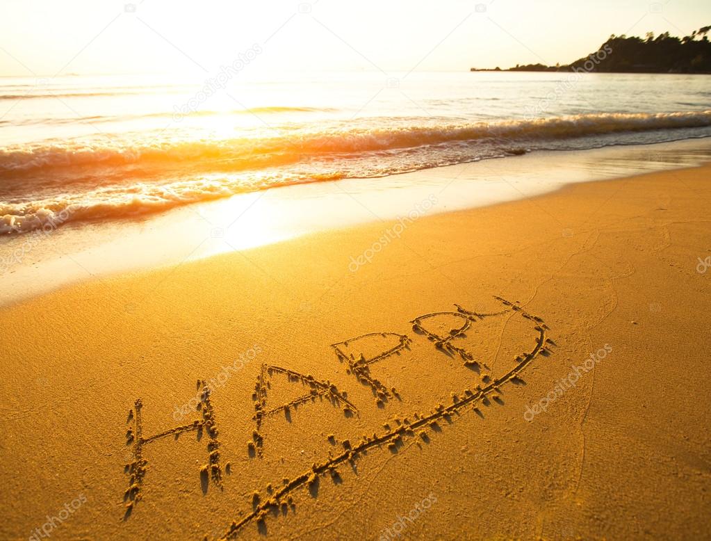 Happy - the inscription on the beach sand