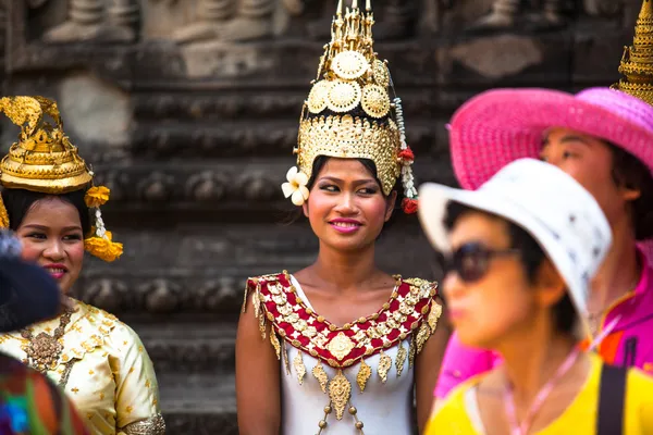 SIEM REAP, CAMBODIA - DEC 13: An unidentified cambodians in national dress poses for tourists in Angkor Wat, Dec 13, 2012 on Siem Reap, Cambodia. Angkor is the country's prime attraction for visitors. Royalty Free Stock Images