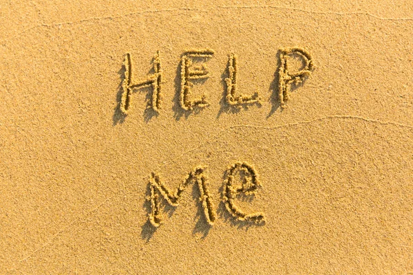 Inscription Help Me - on the sand of tropical beach.