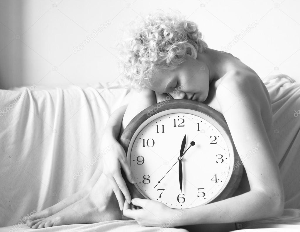 Scrawny girl with big clock in hands,