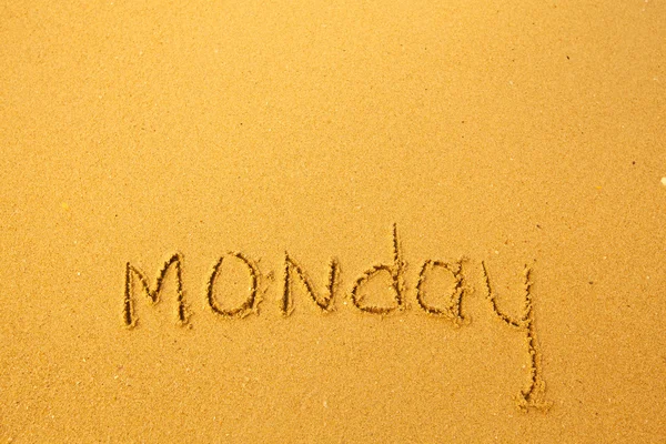 Monday - written in sand on beach texture. — Stock Photo, Image