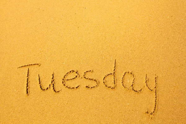 Tuesday - written in sand on beach texture. — Stock Photo, Image
