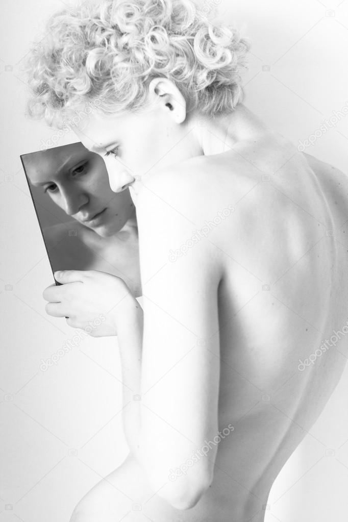 Young skinny sexy girl and mirror, black-and-white photo (studio, isolated)