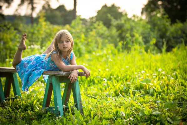 Charmig liten flicka i gården av ett hus på landet — Stockfoto