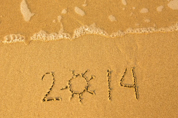 2014 - written in sand on beach texture - soft wave of the sea. Royalty Free Stock Photos