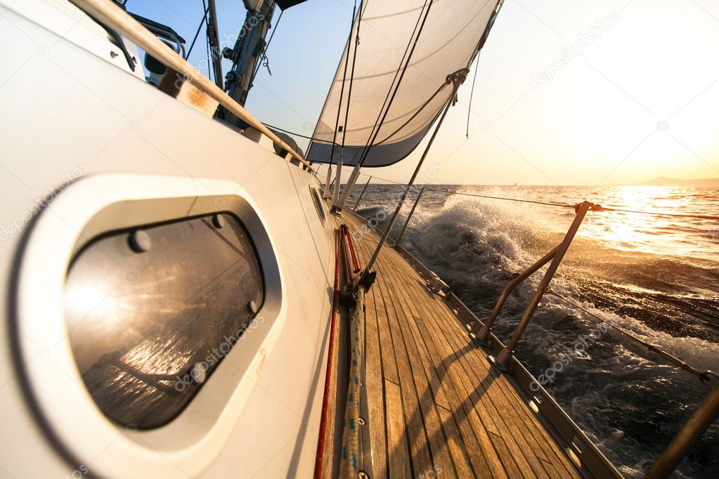 Yacht sailing towards the sunset.