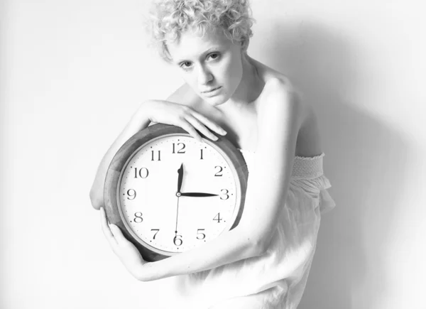 Scrawny blond girl with big clock in hands — Stock Photo, Image