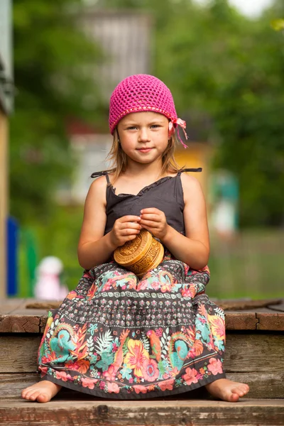 Hermosa niña de cinco años en el porche de una casa de pueblo . — Foto de Stock