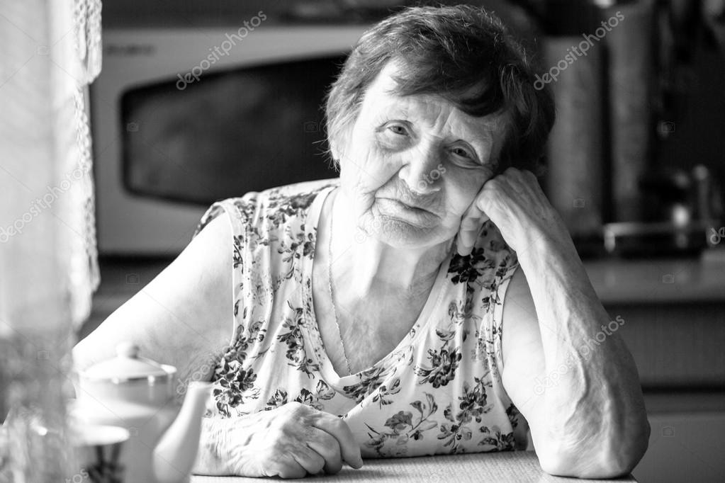 Portrait an old woman at his home