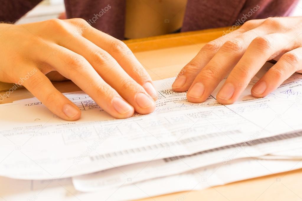 A woman while sorting her old receipts.