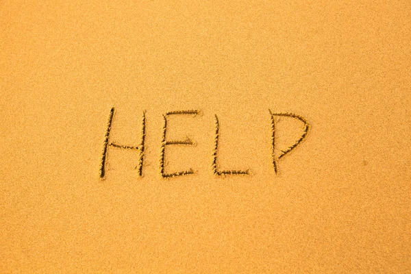 Pomoc - napisał w piasku — Zdjęcie stockowe