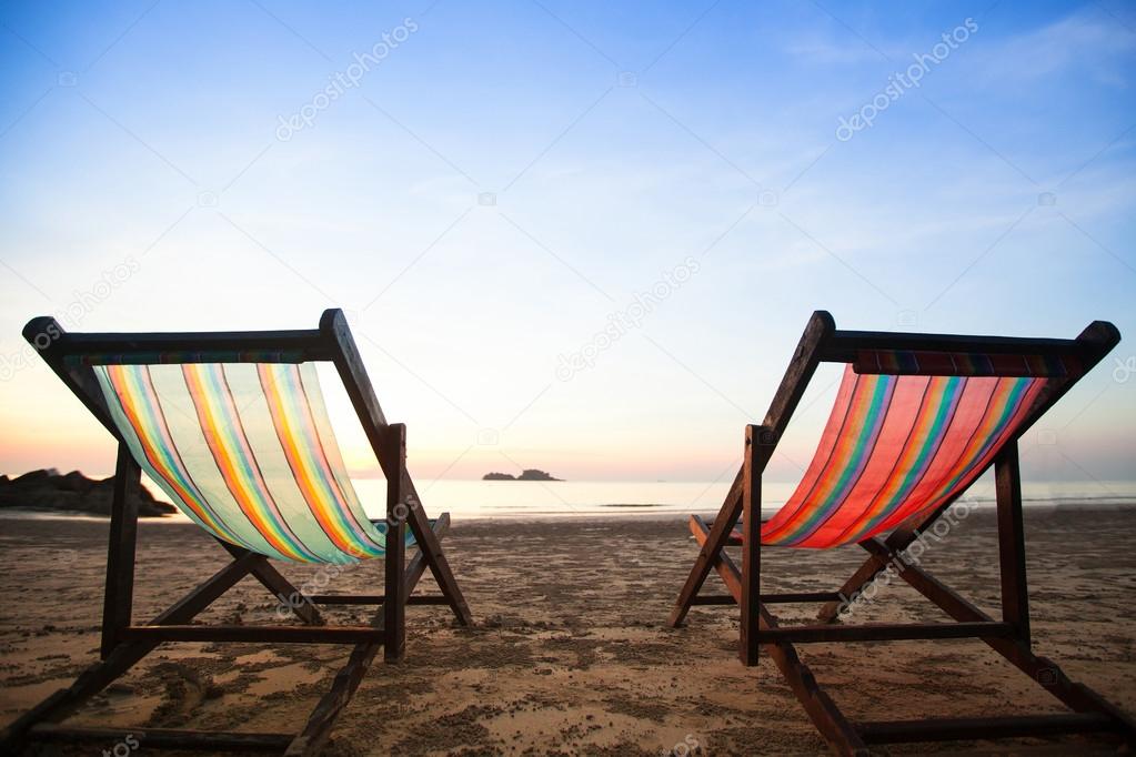 Beach chairs on sea coast.