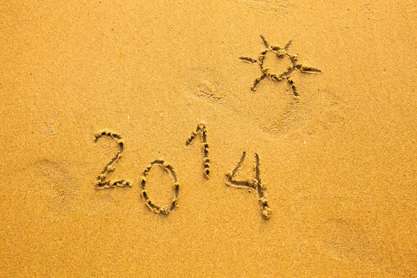 2014 and the sun written in sand Stock Image