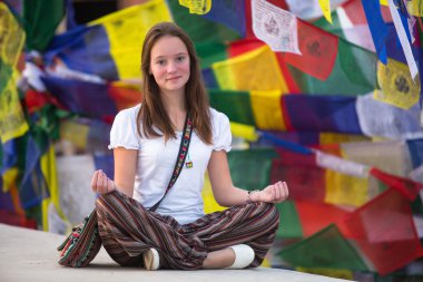 Girl sitting in the Lotus position clipart