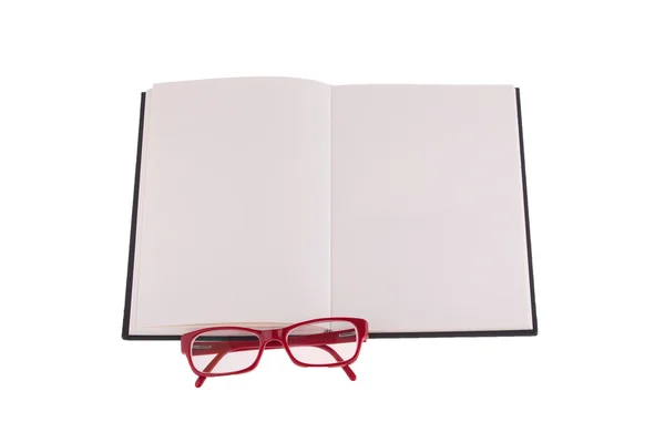 Red glasses placed on notebook — Stock Photo, Image