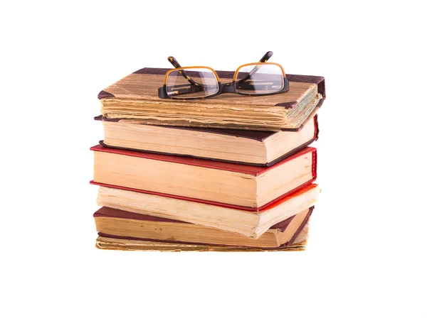 Hromadu starých knih a brýle — Stock fotografie