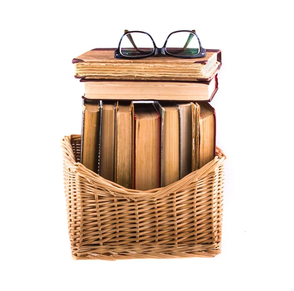 Stack of old antique books in basket — Stock Photo, Image