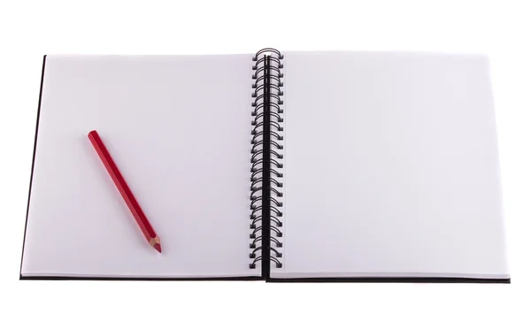 Red pencil placed on notebook — Stock Photo, Image