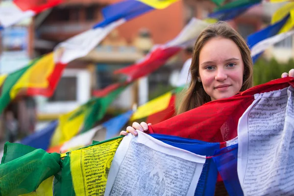 Teengirl and Buddhist prayer flags. — Stock Photo, Image