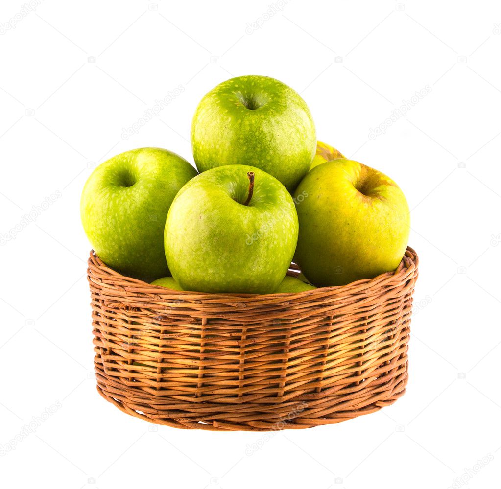 Fresh green apples in a wooden basket