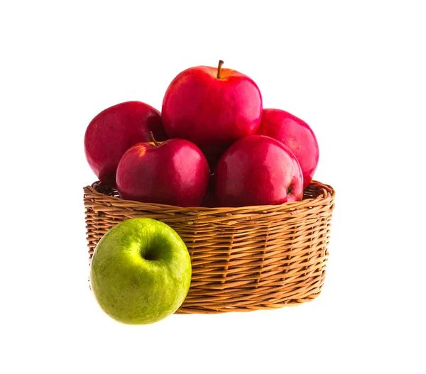 Red and green apples in a wooden basket — Stock Photo, Image