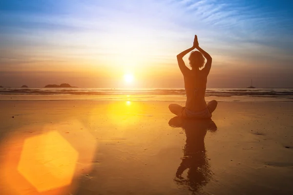 Yoga woman sitting on sea Royalty Free Stock Photos