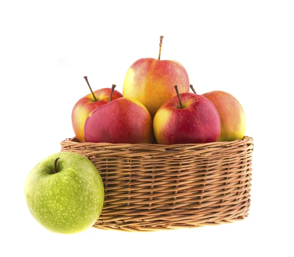 Red and green apples in a wicker baskets — Stock Photo, Image