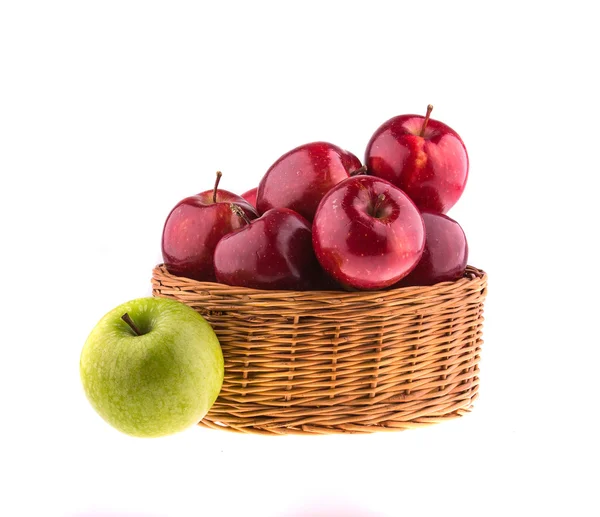 Red and green apples in a wicker baskets — Stock Photo, Image