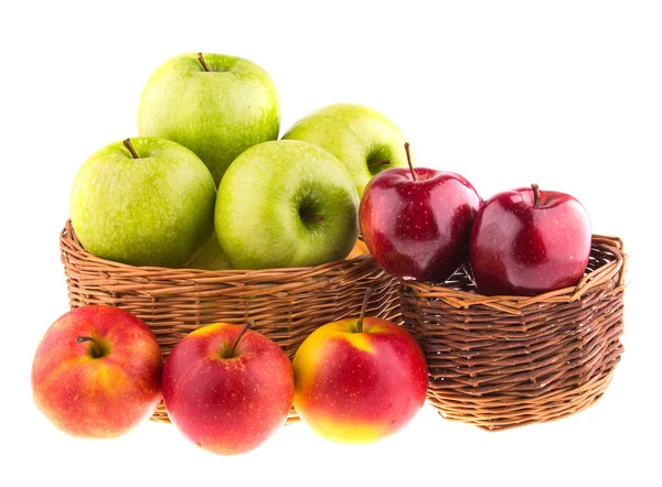 Green and red apples in a wicker baskets — Stock Photo, Image