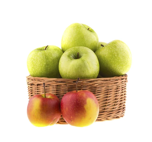 Green and red apples in a wicker baskets — Stock Photo, Image