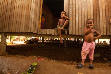 Unidentified children Orang Asli in his village clipart