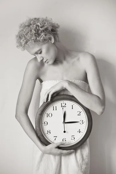 Young tender girl with big clock in hands — Stock Photo, Image