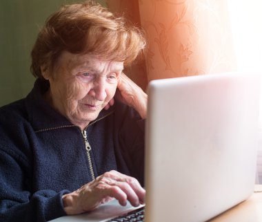 Laptop kullanan yaşlı kadın