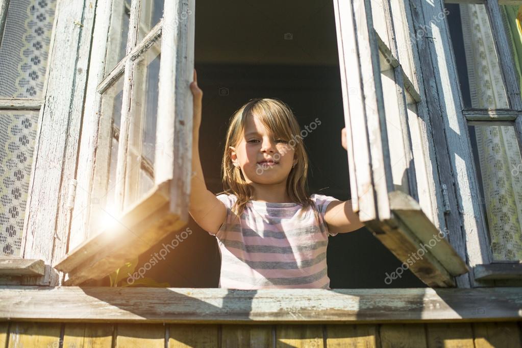Little girl looks out the window