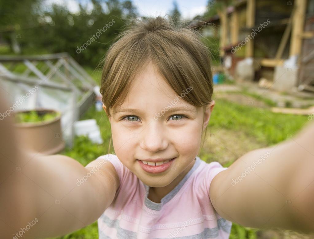 Funny little girl taking selfie — Stock Photo © dimaberkut 49858353