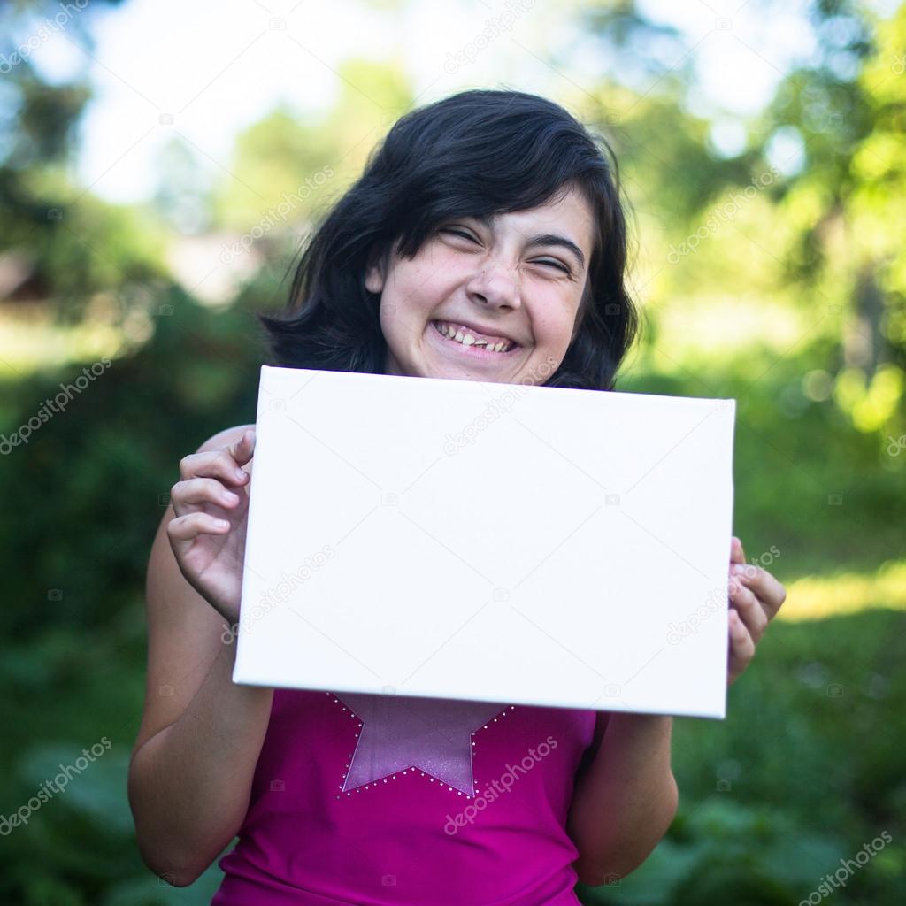 Fun girl holding clean white sheet paper