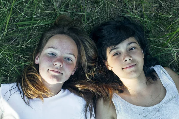 Portret Van Twee Tienermeisjes Liggend Het Gras Een Close Opname — Stockfoto