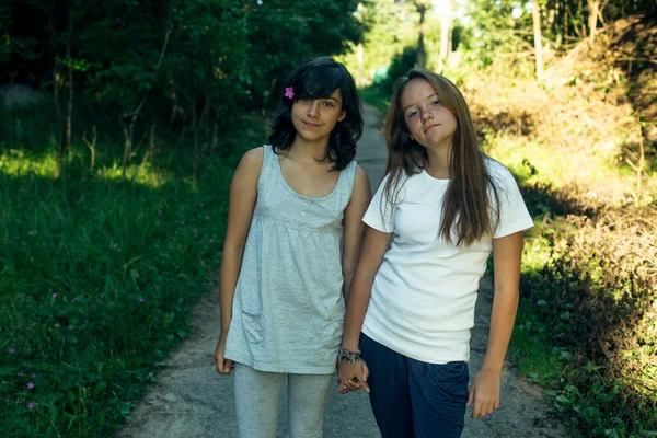 Two Teenage Sisters Pose Holding Hands Park Stock Image