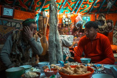 MONGOLIAN ALTAI, MONGOLIA - SEP 28, 2017: Kazakhs family of hunters with hunting golden eagles inside their the mongolian Yurts. In Bayan-Olgii Province is populated to 88,7% by Kazakhs.