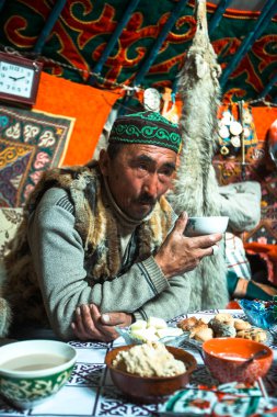 MONGOLIAN ALTAI, MONGOLIA - SEP 28, 2017: Kazakhs family of hunters with hunting golden eagles inside their the mongolian Yurts. In Bayan-Olgii Province is populated to 88,7% by Kazakhs.
