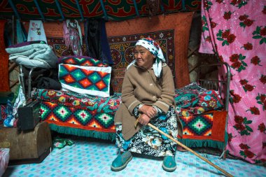 MONGOLIAN ALTAI, MONGOLIA - SEP 28, 2017: Kazakhs family of hunters with hunting golden eagles inside their the mongolian Yurts. In Bayan-Olgii Province is populated to 88,7% by Kazakhs.