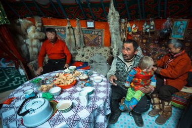 MONGOLIAN ALTAI, MONGOLIA - SEP 28, 2017: Kazakhs family of hunters with hunting golden eagles inside their the mongolian Yurts. In Bayan-Olgii Province is populated to 88,7% by Kazakhs.