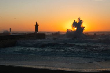 Lighthouse with huge wave at Atlantic ocean, Porto, Portugal.