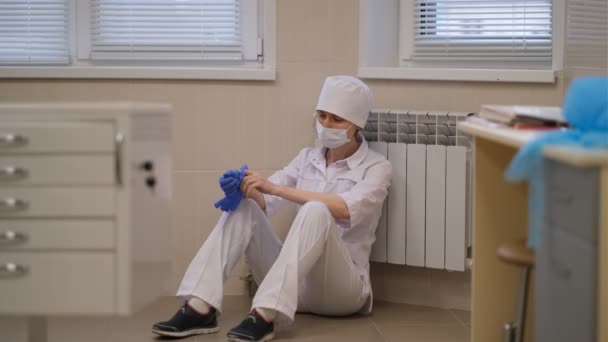 Tense Exhausted Female Doctor Sits Tiredly Hospital Floor Wearing Face — Stock Video