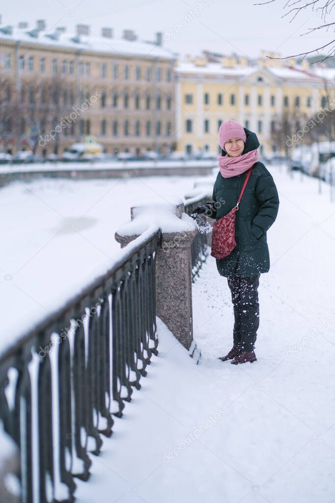 A woman standing near Griboedov Canal in winter, St. Petersburg, Russia. 
